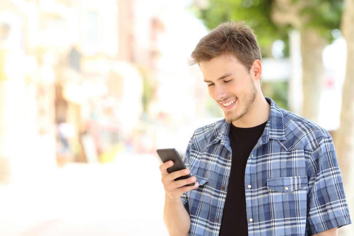 man-texting-smiling